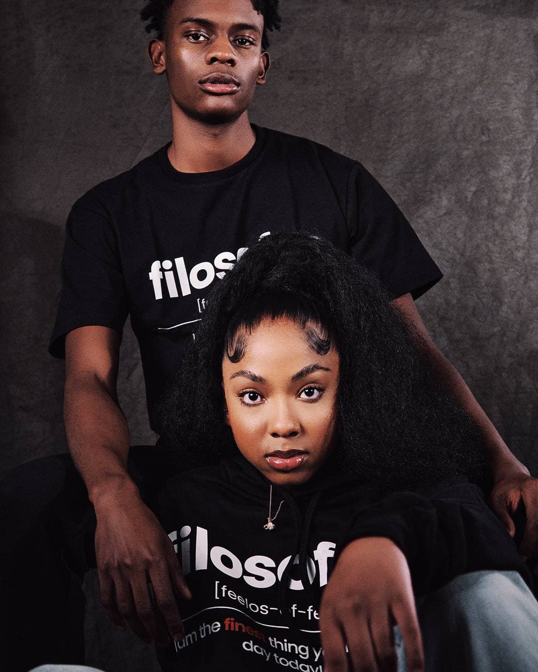 Two models in Filosofee tees against a studio backdrop